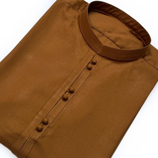 Men's Camel Color Pakistani Kurta Pajama This men's kurta pajama set is a perfect blend of elegance and comfort. Made with premium wash-and-wear fabric, it offers durability and a smooth finish. The stylish camel-colored kurta features a ban-style collar and same-color fabric buttons, giving it a modern yet traditional look. The matching design adds sophistication, making it suitable for casual and festive occasions. The set includes a white trouser that complements the camel kurta, creating a balanced and polished appearance. Available in sizes S, M, L, and XL, this outfit ensures a comfortable fit for everyone. It’s easy to care for and ideal for daily wear or special gatherings. Whether you're updating your wardrobe or looking for Men's Camel Color Pakistani Kurta Pajama Wholesale, this set combines style, comfort, and versatility in one package.