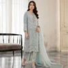 Light Grey Pakistani Chiffon Suit USA Add a soft and dreamy touch to your wardrobe with this Lilac Pakistani Chiffon Suit USA. This luxury 3-piece outfit features premium chiffon fabric in a beautiful lilac lavender shade. Furthermore, dense silver thread and sequin work gives the shirt a rich and elegant look. The intricate embroidered neckline adds a graceful finish. The scalloped hemline features delicate bead fringes for extra charm. Meanwhile, the flowing chiffon dupatta completes the outfit with its stylish laser-cut border work. The matching wide-leg trousers create a comfortable and modern look. Perfect for festive events, weddings, parties, and semi-formal gatherings, this ready-to-wear Pakistani chiffon suit offers both style and ease. Moreover, its soft color and detailed embellishments make it a beautiful choice for special occasions in the USA.
